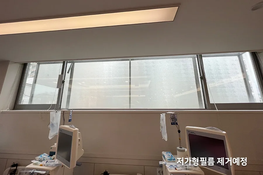 유리창에 부착돼 있던 기존 저가형 필름 표면 전체에 반점처럼 들뜬 자국이 번져 있는 모습